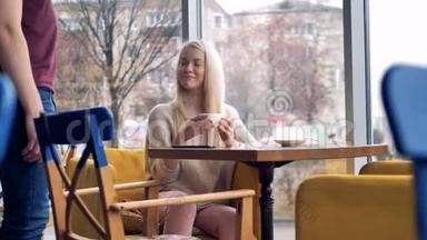 一个女孩坐在咖啡馆的椅子上，为她的饮料买单。